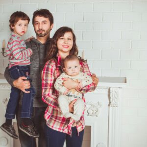A joyful family posing together in a cozy living room, embodying love and togetherness.