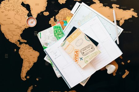 pexels-photo-7235894-7235894 A flat lay of travel planning items on a map, featuring a compass, notebook, and guide for wanderlust enthusiasts.